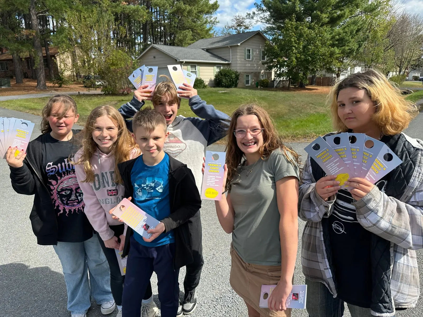 Middle school students outdoors comparing the colour wheels they built in class